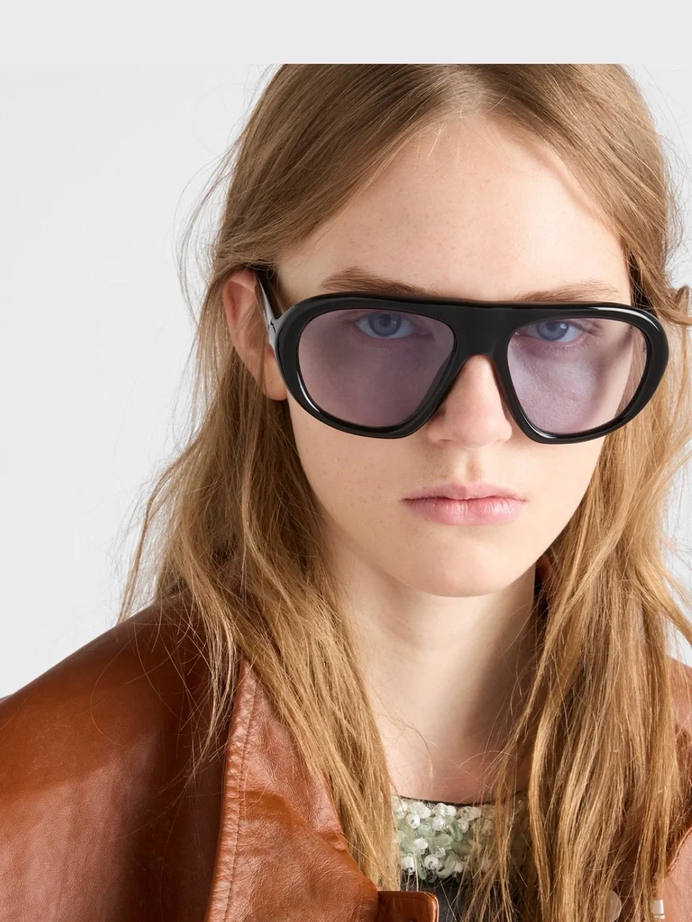 Prada Black Frame Sunglasses with Purple-Tinted Lenses